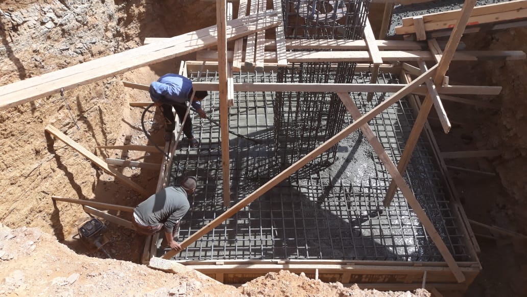 Concrete placement around the foundation reinforcement.