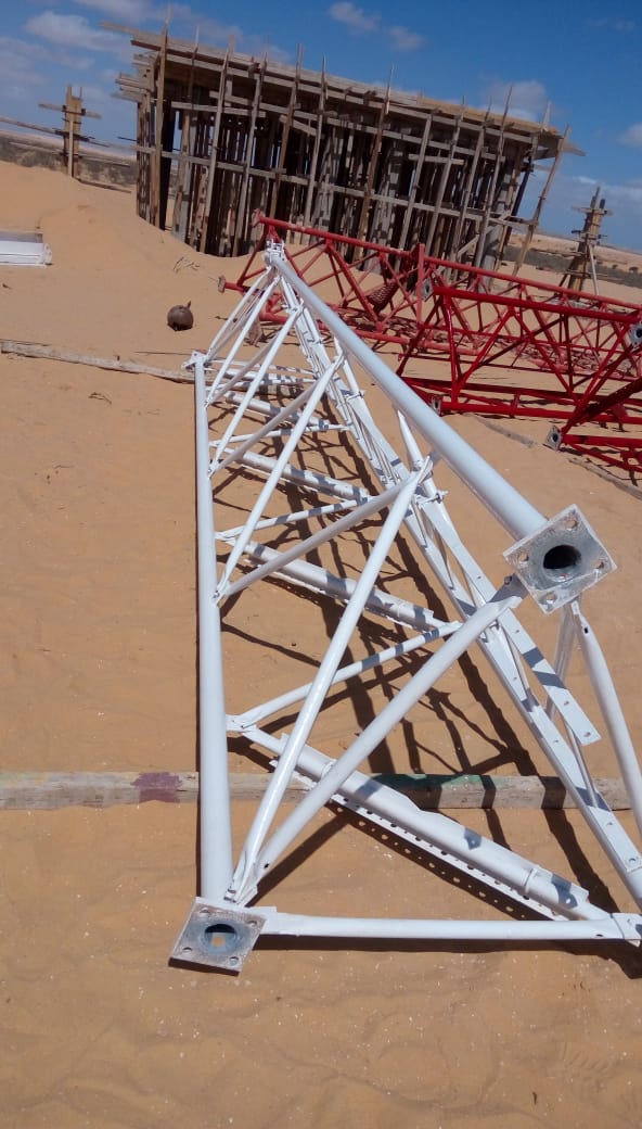 Repainted tower sections laid out at the work site.